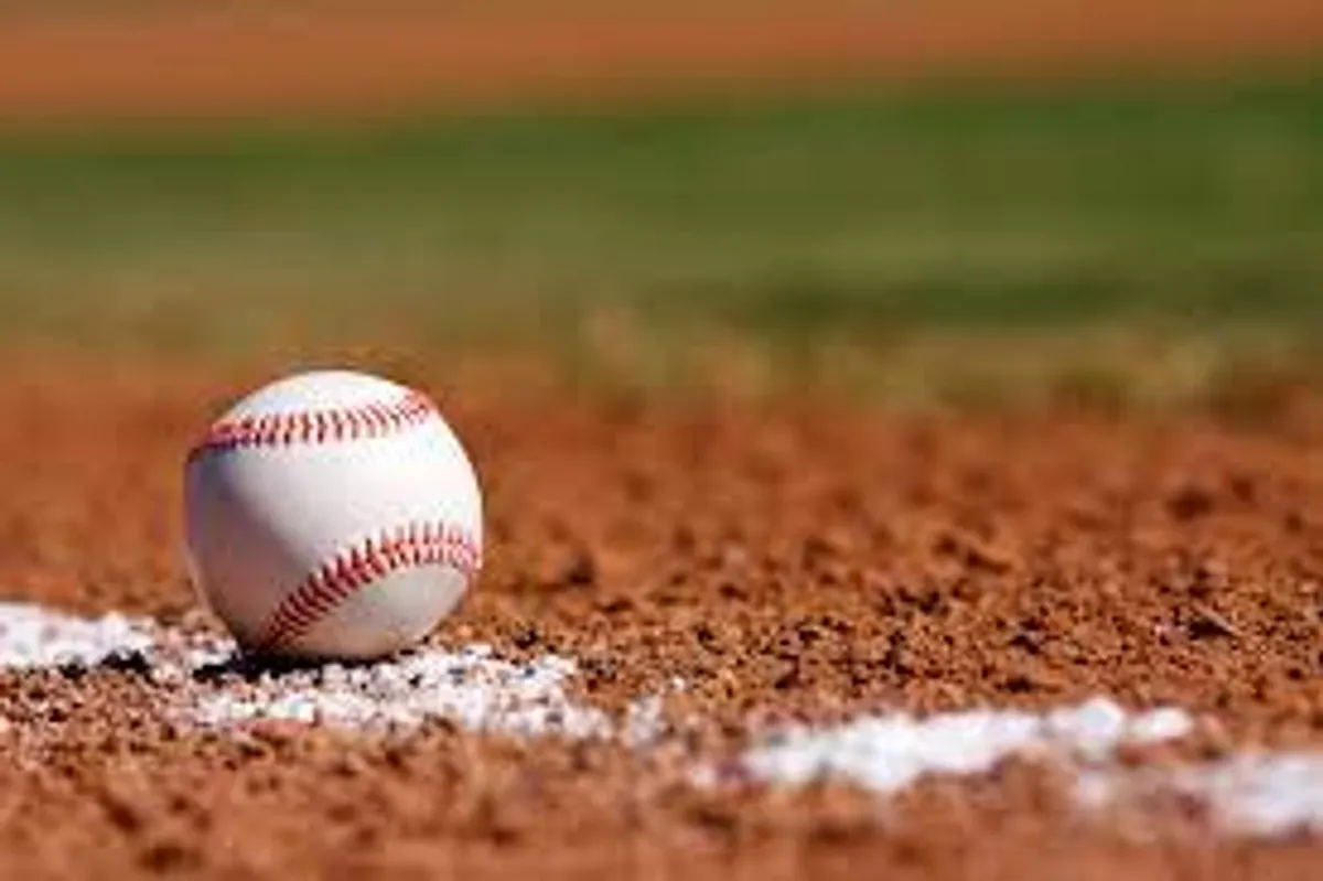 A sunlit outdoor baseball field with a dirt infield and a crisp white chalk line, capturing an energetic and classic slice of Arizona life. The scene evokes local recreation and the vibrant community spirit that characterizes the Southeast Valley.